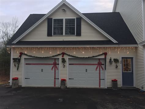 Wrapped garage door, garland, snow flake lights, poinsettias | Garage ...