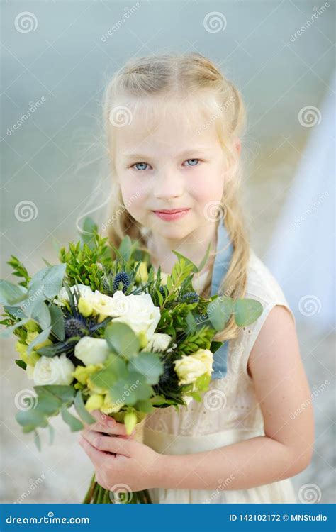Adorable Little Bridesmaid Holding Beautiful Flower Bouquets after Wedding Cemerony Outdoors ...