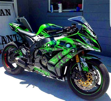 Green and Black Motorcycle Parked in Front of a Building