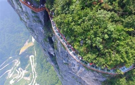 Coiling glass skywalk opened in China lets people walk on a sheer cliff face