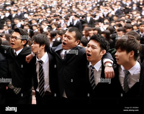 Tokyo, Japan. 1st Mar, 2017. Japanese college students in dark suits place their arms on each ...