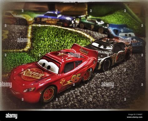 Toy Cars from The Cars Movie Franchise race on a child's race mat Stock ...