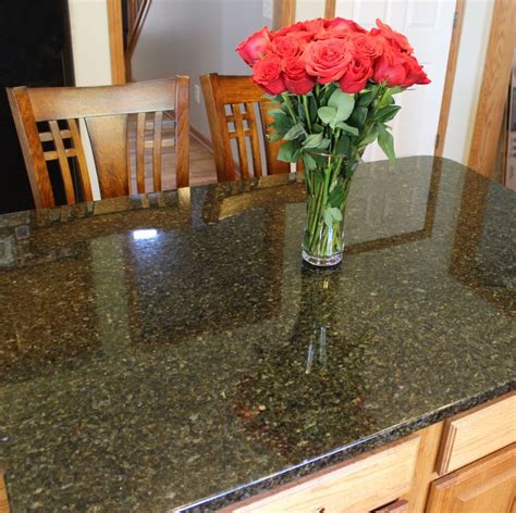 We updated these existing kitchen cabinets with new Ubatuba granite countertops with a small ...