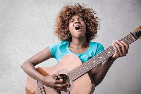 Woman Playing Acoustic Guitar While Singing · Free Stock Photo