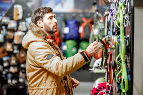 Man Choosing Choosing Mountaineer Equipment in the Shop Stock Photo - Image of parka, choise ...