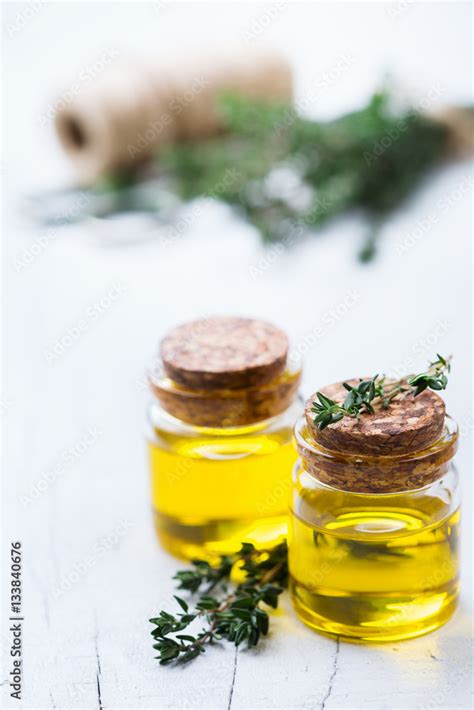 Organic essential thyme oil with green leaves Stock Photo | Adobe Stock