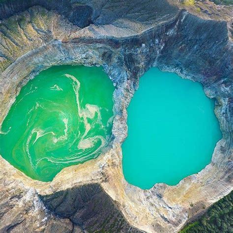 The Kelimutu Crater lakes are at the summit of a volcano. It is in ...