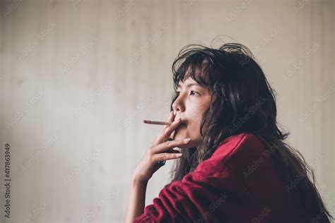 Stressed woman. A depressed woman smoking of stress Caused by social problems It's a concept ...