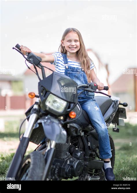 little girl driving a motorcycle Stock Photo - Alamy