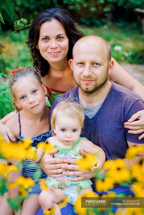 Portrait Of Happy Family In Garden At Home — four, child - Stock Photo ...