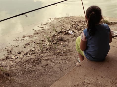 Premium Photo | Girl fishing in lake