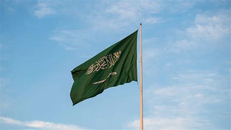 a green flag flying in the wind on a sunny day