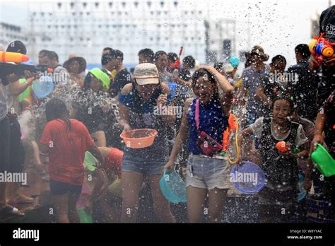 Crowds of local people splash water to celebrate the New Year of Dai ethnic minority on the ...