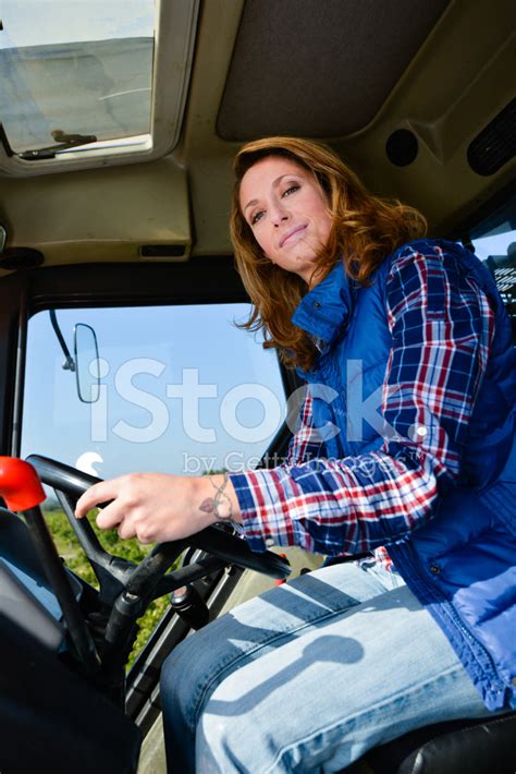 Beautiful Woman Farmer Driving Tractor IN Fields During Harvest Stock Photos - FreeImages.com