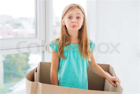 Girl making sad grimace inside the box | Stock image | Colourbox