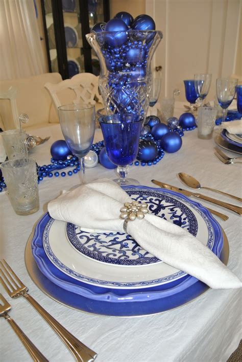 a blue and white table setting with silverware