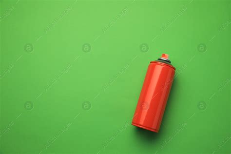 Can of red graffiti spray paint on green background, top view. Space for text: Stock Photo ...