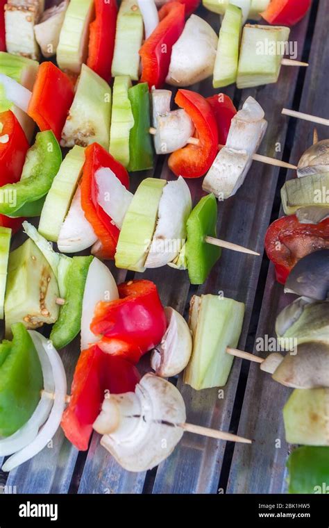 Vegetable skewers grilling on the barbecue Stock Photo - Alamy