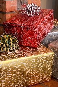 Royalty-Free photo: Woman wearing Santa hat while holding red gift ...