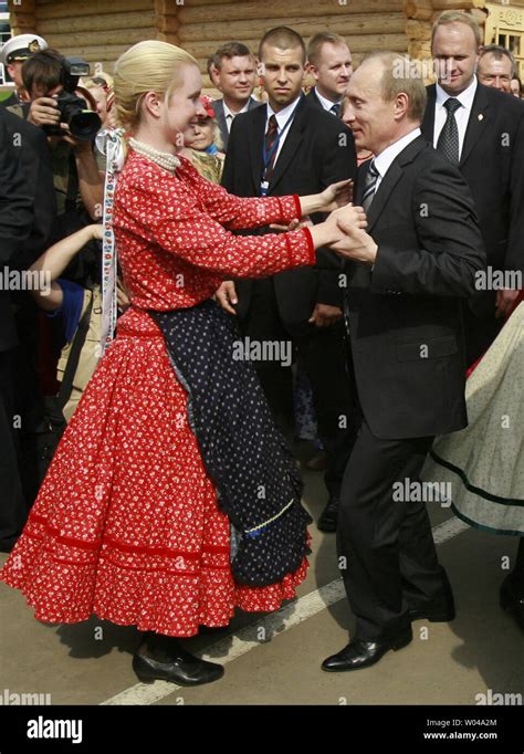 Russian President Vladimir Putin dances at a festival celebrating Finno ...