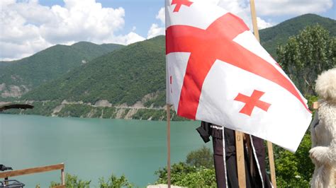 The Flag of Georgia and traditional costume on a Lake in Kavkaz Mountains Stock Video Footage 00 ...