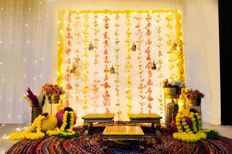 Enjoy your Haldi and Mehndi event with a Colourful hanging backdrop decoration that promises ...