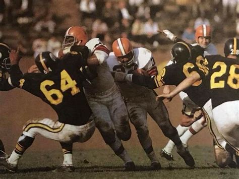 Jim Brown running against the Pittsburgh Steelers. One of the greatest running backs of all time ...