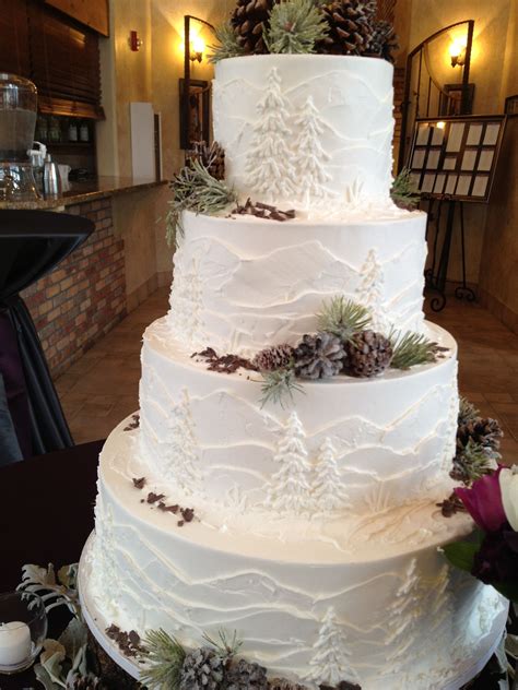 White frosted cake with mountains and pine trees, perfect for an ...