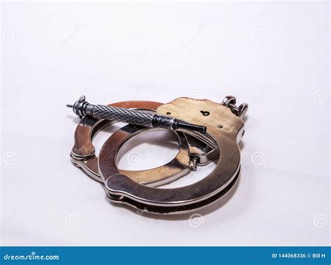 A Pair of Silver Metal Handcuffs with a Black Handcuff Key Stock Photo - Image of iron, police ...