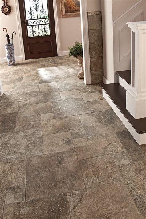 When it comes to home entryways, practicality is key! Consider a stone-look floor tile, which ...