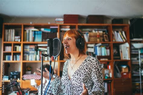 Singer performing song into microphone at home Stock Photo | Adobe Stock