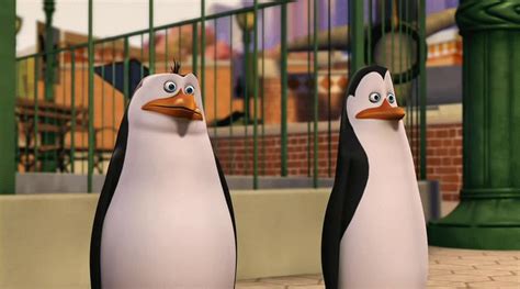 two animated penguins standing next to each other