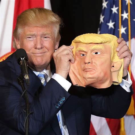 Donald Trump Holds Trump Mask Onstage at Florida Rally