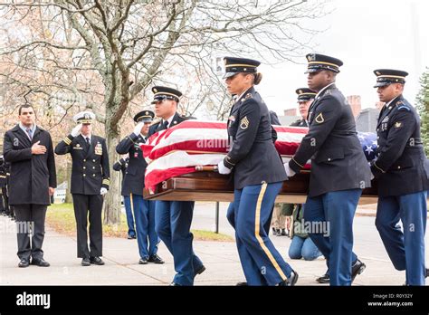 Military Funeral Honors Team of the Massachusetts Army National Guard carries the casket of ...