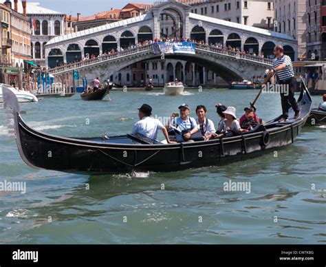 The Rialto Bridge spans the Grand Canal Venice, Italy Stock Photo - Alamy