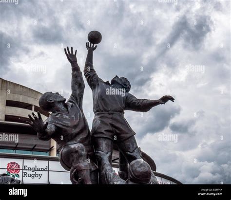 Twickenham Rugby Union stadium and bronze sculpture of Rugby players leaping for a rugby ball ...