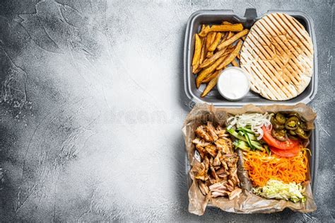 Doner Kebab Shawarma on a Plate with French Fries and Salad in Box To Go, Take Away. White ...