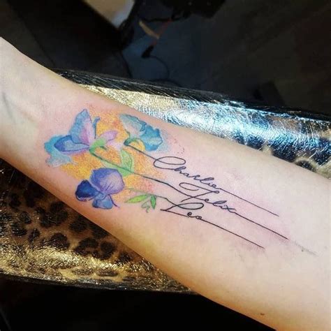 a woman with a tattoo on her arm that has flowers and the words dear ...