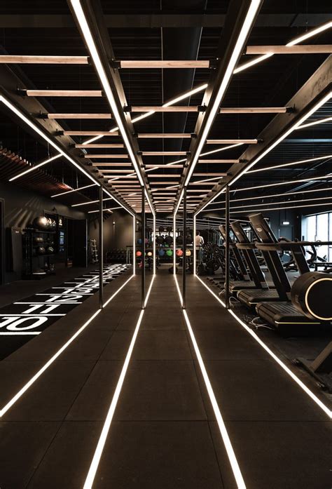 an indoor gym with treadmills and lights