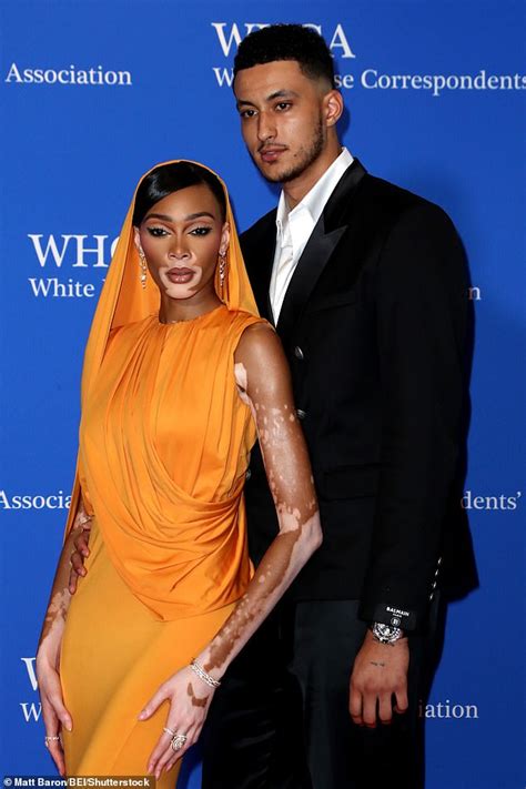 Winnie Harlow wows in an eye-catching orange hooded gown alongside ...