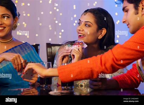 Family members playing cards on dining table on the occasion of Diwali Stock Photo - Alamy