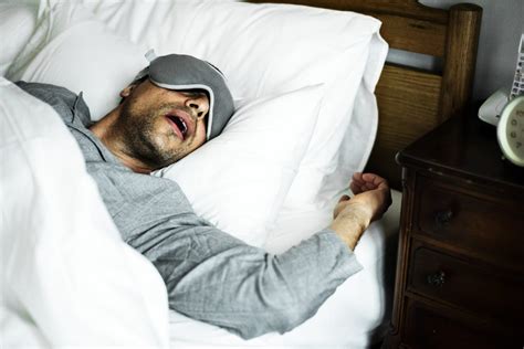 A man sleeping on a bed – International Institute of Sleep