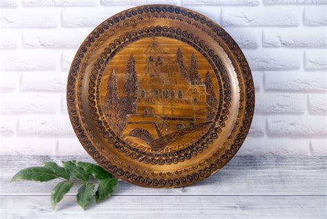 a wooden plate sitting on top of a white brick wall