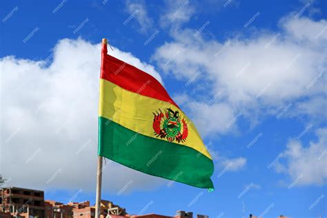 Premium Photo | Flag of bolivia waving on vibrant blue sky