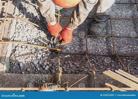 A Worker Uses Steel Tying Wire To Fasten Steel Rods To Reinforcement ...