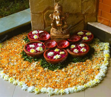 Premium Photo | Floral rangoli at home rangoli made using flowers ganpati rangoli ganesha decor ...