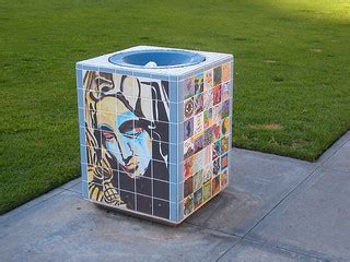 face collage art on trash can in the park | Justin Henry | Flickr