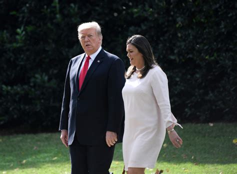 President Donald Trump walks with White House Press Secretary Sarah ...