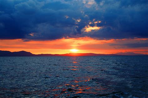 Photo of Sunset over Large Body of Water · Free Stock Photo