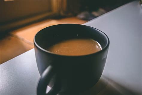 Shallow Focus Photography of Black Ceramic Mug Filled With Brown Coffee on the Table · Free ...